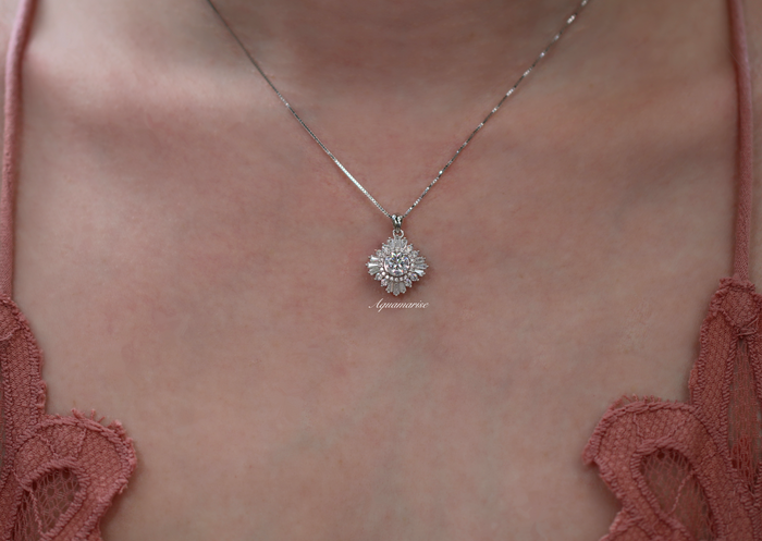 Joelle Simulated Diamond Starburst Pendant Necklace in Sterling Silver by Aquamarise, featuring a vintage-inspired starburst design with radiant simulated diamonds on a delicate sterling silver chain.