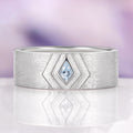 Elowen Aquamarine Couples Ring Set by Aquamarise features a modern sterling silver band with a rhodium finish, showcasing a unique kite-shaped aquamarine gemstone, part of Matching Couples' Rings and March Birthstone Jewelry collections.
