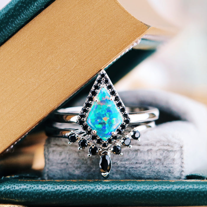 Galaxy Green Fire Opal Couples Ring Set by Aquamarise featuring a glowing green fire opal in a diamond shape surrounded by black stones on polished silver bands symbolizing unity.