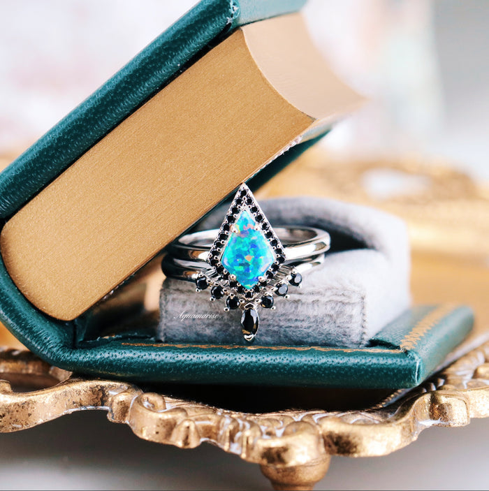 Galaxy Green Fire Opal Couples Ring Set by Aquamarise featuring a glowing diamond-shaped green fire opal framed by black stones on polished silver bands in a delicate gift box.