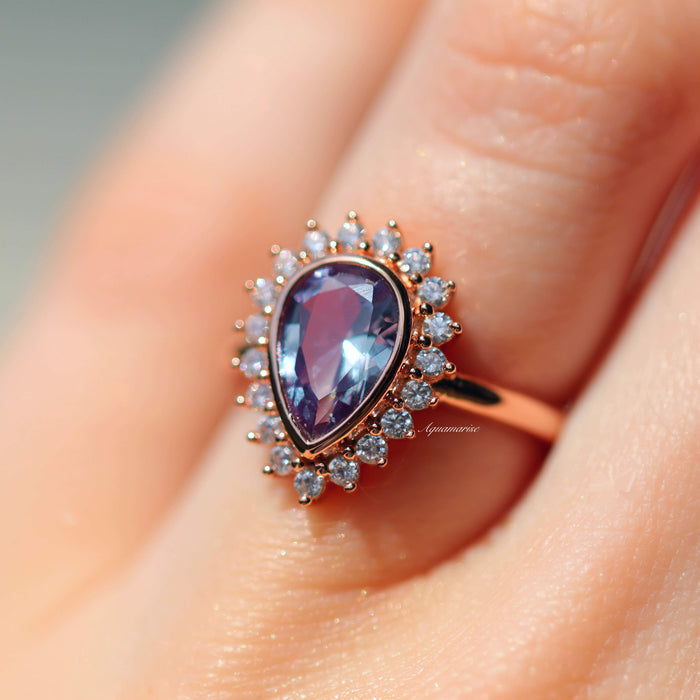 Lab Alexandrite Halo Engagement Ring in Solid 14K Rose Gold showcasing a pear-cut lab-grown alexandrite with a moissanite halo by Aquamarise Gold in a romantic rose gold setting.