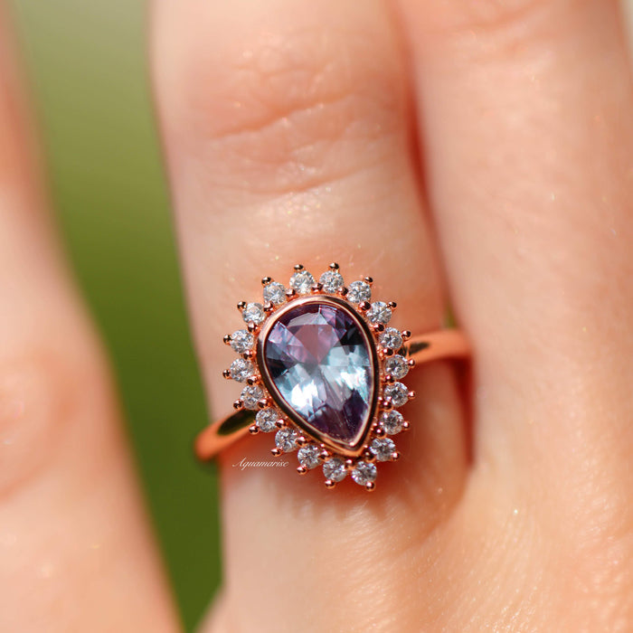 Lab Alexandrite Halo Ring in 14K Rose Gold Vermeil by Aquamarise featuring a pear-shaped lab-grown alexandrite surrounded by a halo of sparkling cubic zirconia on a delicate rose gold band.