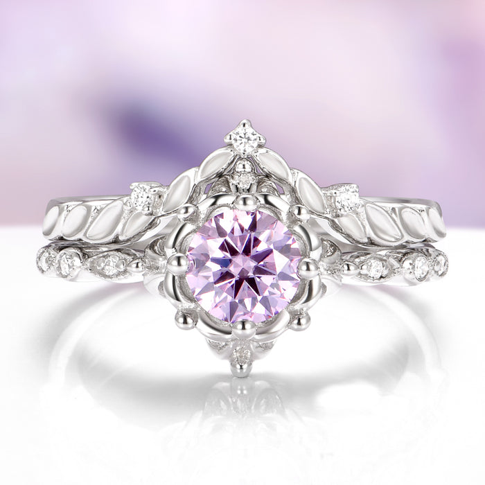 Silver ring with a pink gemstone on a white background