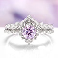 Silver ring with a pink gemstone on a white background