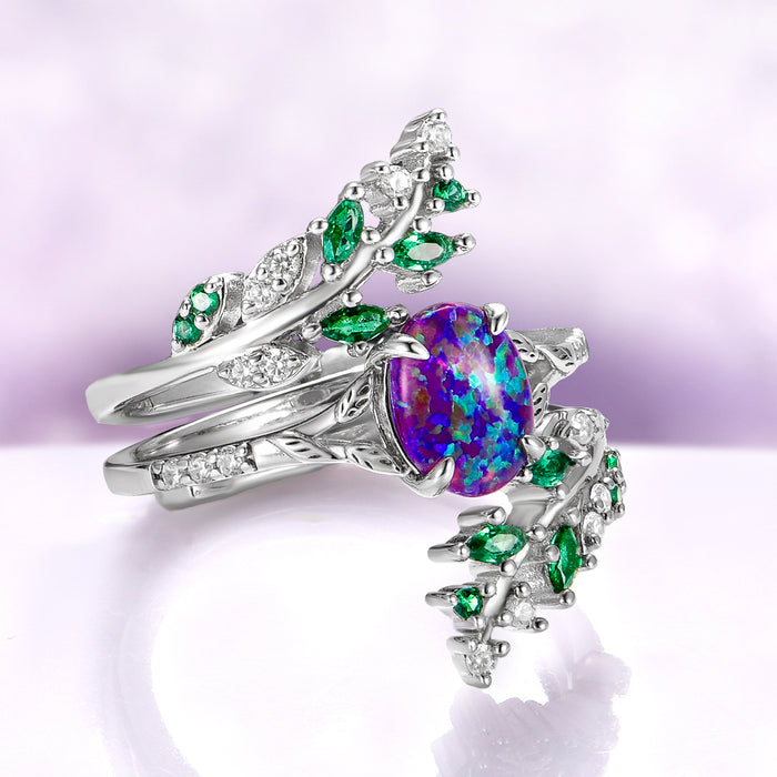 Lavender Fire Opal & Emerald Leaf Couples Ring Set featuring a vibrant purple opal and emerald accents on sterling silver bands by Aquamarise, unique matching fantasy-inspired couple rings.