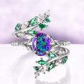 Lavender Fire Opal & Emerald Leaf Couples Ring Set featuring a sterling silver band with vibrant purple opal center and emerald leaf accents by Aquamarise, unique matching couples rings.