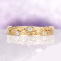 Diamond Leaf Wedding Band in Solid 14K Yellow Gold by Aquamarise Gold, featuring delicate leaf motifs accented with sparkling diamonds on a finely crafted yellow gold band, part of elegant women’s wedding bands and nature-inspired collections.