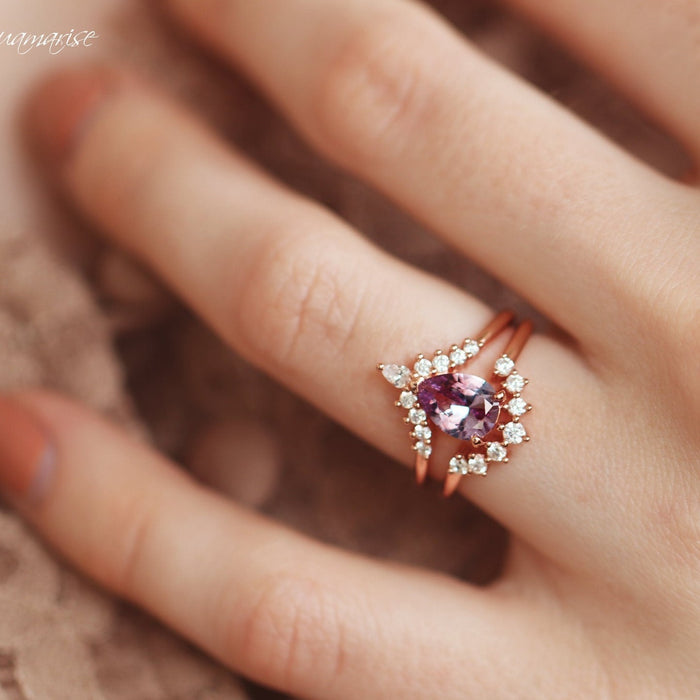 Lunette Teardrop Alexandrite Ring Set in 14K Rose Gold Vermeil by Aquamarise featuring a teardrop alexandrite and diamond accents on a rose gold vermeil band, styled on hand against a soft background