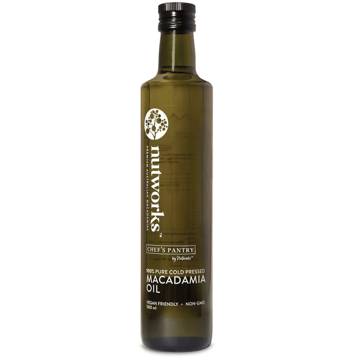 A bottle of macadamia oil 500 ml with a label that includes the brand name 'Nutworks' and the product name 'Macadamia Oil'. The bottle is dark glass with a white label and green text.