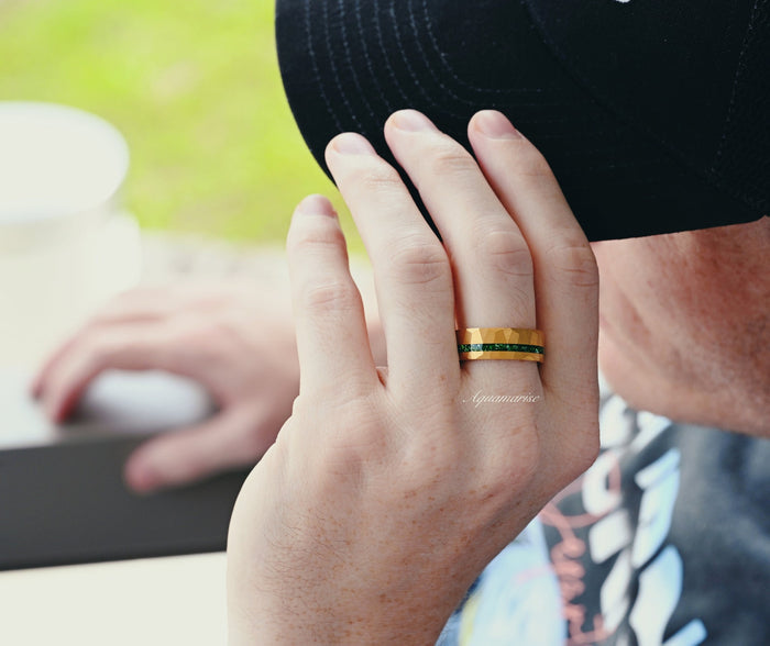 Maeve Emerald Couples Ring Set worn on hand, featuring a 925-sterling silver ring with 14k yellow gold finish and emerald stones, by Aquamarise in a casual outdoor setting.