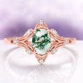 Maeve Green Moss Agate Ring- 14K Solid Rose Gold by Aquamarise Gold, featuring an oval green moss agate gemstone set in an ornate rose gold band accented with sparkling white stones, blending vintage charm with nature-inspired elegance.