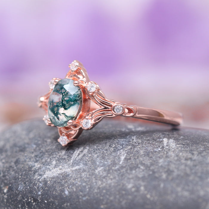 Maeve Green Moss Agate Ring- 14K Solid Rose Gold by Aquamarise Gold, featuring an oval green moss agate gemstone set in a vintage-inspired rose gold band accented with delicate sparkling white stones, part of nature-inspired engagement and birthstone jewelry collections.