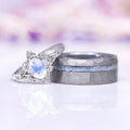 Crushed Moonstone men's tungsten wedding band shown beside the Maeve vintage moonstone engagement ring as a matching couples set by Aquamarise