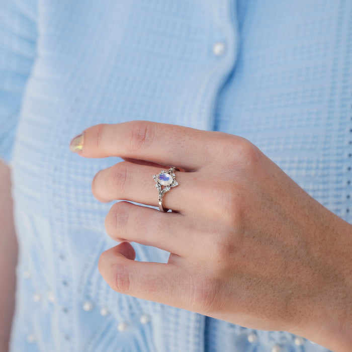 Maeve Vintage Moonstone Engagement Ring in 14K White Gold by Aquamarise Gold, featuring an oval moonstone with subtle blue flashes set in an intricate vintage-inspired band, part of Solid Gold Engagement Rings and Nature-Inspired Engagement Rings collections.