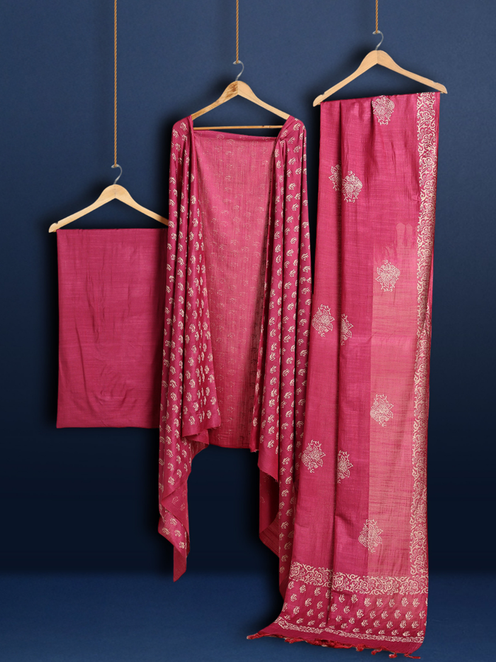 Magenta katan silk unstitched suit set with cream botanical hand block print and a lengthwise printed border on the dupatta
