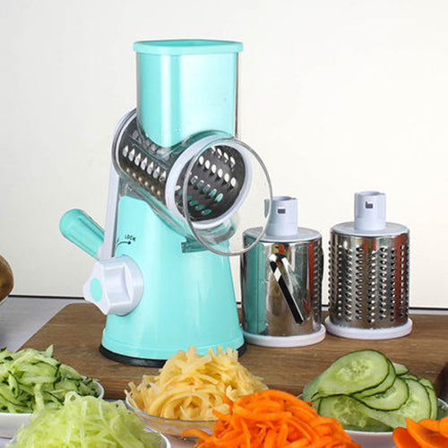 Multifunctional mandoline vegetable slicer in turquoise color with various grating attachments and sliced vegetables.