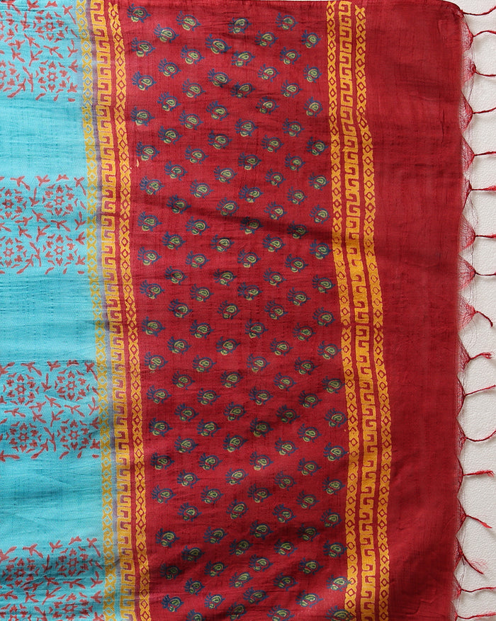 Maroon katan silk unstitched suit set hand block printed with small turquoise botanical motifs and angular geometric key-pattern bands at the ends.
