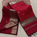 Maroon Maheshwari silk saree with small gold buti across the body and a wide checked gold and black border, handwoven in Maheshwar