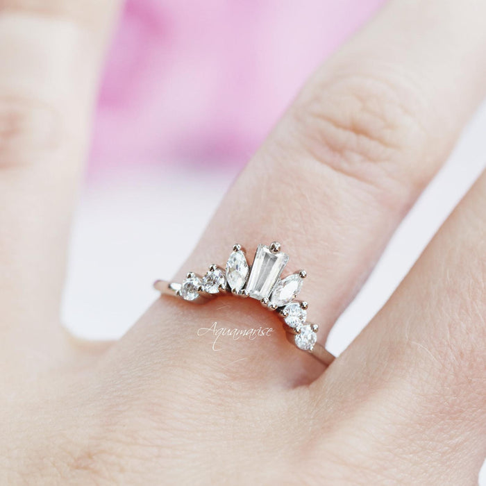 Art Deco Cluster Diamond Wedding Band- Sterling Silver by Aquamarise featuring marquise and baguette simulated diamonds in a curved design, shown on a hand with soft lighting.