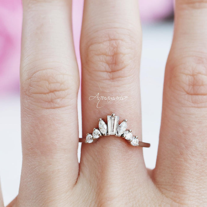 Art Deco Cluster Diamond Wedding Band- Sterling Silver by Aquamarise featuring marquise and baguette simulated diamonds in a curved design on hand with soft natural lighting.