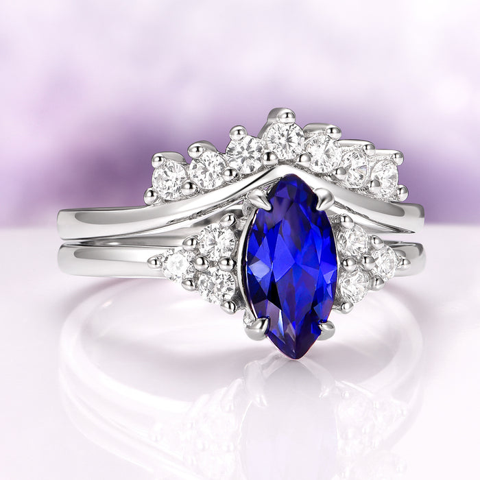 Marquise Cut Blue Sapphire Bridal Ring Set in Sterling Silver by Aquamarise featuring a deep royal blue marquise sapphire with sparkling white accents on a polished sterling silver band.