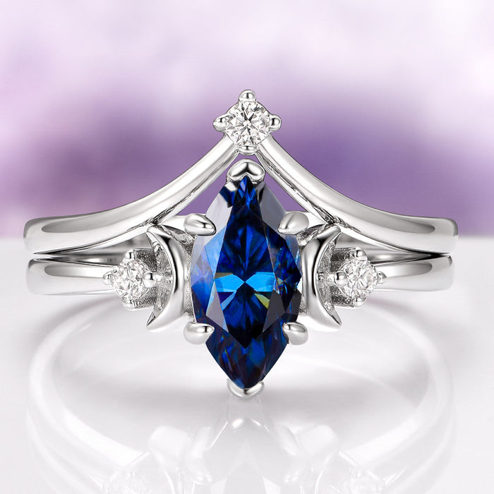 Midnight Blue Moissanite Crescent Moon Engagement Ring Set in 14K White Gold by Aquamarise Gold, featuring a marquise-cut deep blue moissanite center stone accented with crescent-shaped details and small sparkling diamonds, part of Solid Gold Engagement Rings, Moissanite Engagement Rings, and Meaningful Jewelry Gifts collections.