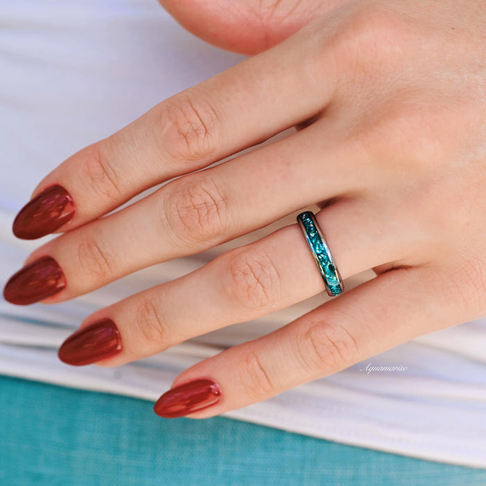 Crushed Aquamarine Wedding Band- 4MM Tungsten worn on hand, showcasing a vibrant crushed aquamarine inlay set in a sleek tungsten band by Aquamarise.