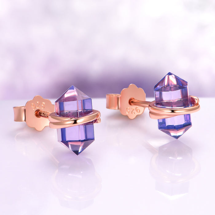 Minimalist Raw Alexandrite Stud Earrings in 14K Rose Gold Vermeil by Aquamarise feature polished rose gold bands wrapping raw violet-hued alexandrite crystals for elegant June Birthstone Jewelry.