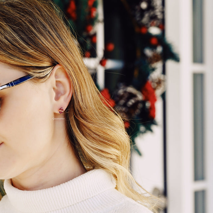 Minimalist Raw Alexandrite Stud Earrings in 14K Rose Gold Vermeil worn by woman with glasses, showcasing elegant raw alexandrite stones in rose gold by Aquamarise.