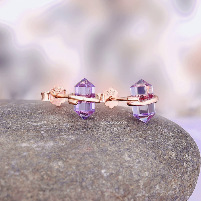 Minimalist Raw Alexandrite Stud Earrings in 14K Rose Gold Vermeil by Aquamarise feature hexagonal raw purple alexandrite crystals wrapped in smooth rose gold for delicate June birthstone jewelry.