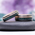 Moss Agate Two Tone Black Rose Gold Tungsten Couples Ring Set by Aquamarise featuring dark tungsten bands with green moss agate inlay and polished rose gold accents for matching couples rings.