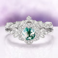 Moss Agate Fairy Leaf Ring Set in 14K White Gold by Aquamarise Gold, featuring a green moss agate center surrounded by leaf and diamond accents, embodying nature-inspired elegance.