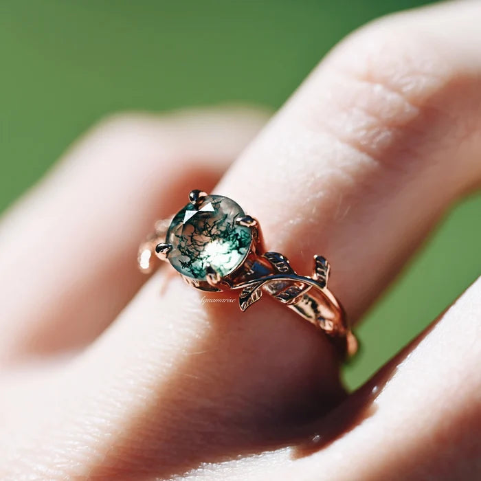 Moss Agate Leaf Ring in 14K Rose Gold Vermeil by Aquamarise, featuring a round green moss agate stone with a detailed leaf-inspired rose gold vermeil band on finger.