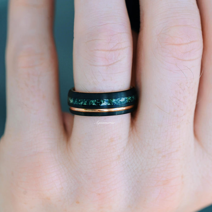 Moss Agate Wedding Band- 8MM Black & Rose Gold Tungsten featuring a polished rose gold accent and a dark green moss agate inlay, displayed on a finger, crafted by Aquamarise from men's two-tone and nature-inspired jewelry collections.