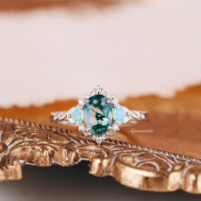Moss Agate & Opalescent Sapphire Engagement Ring in 14K White Gold by Aquamarise Gold featuring a nature-inspired moss agate center with opalescent sapphires and diamond accents on a detailed band.