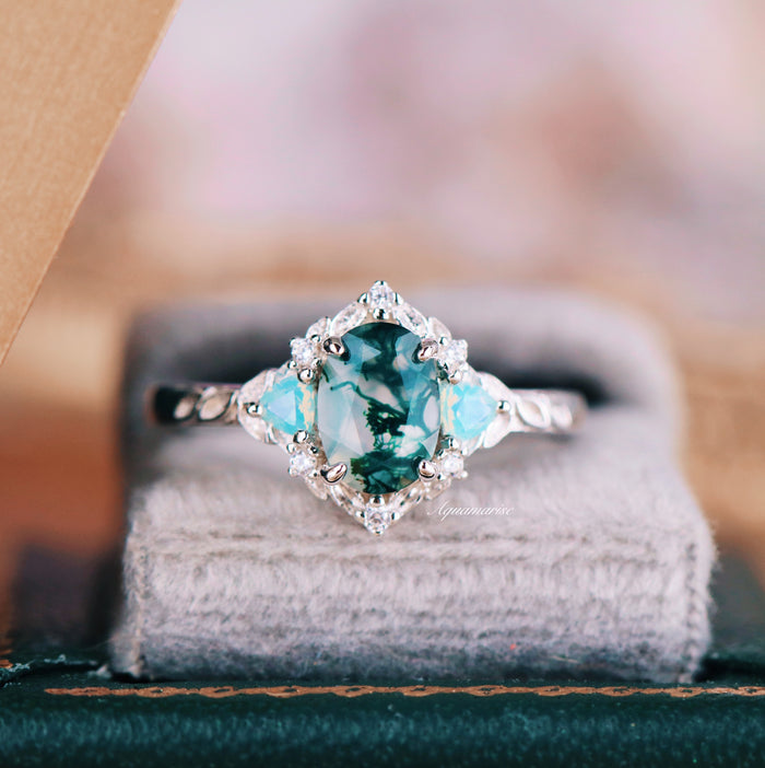 Moss Agate & Opalescent Sapphire Engagement Ring in 14K White Gold by Aquamarise Gold featuring a transparent green moss agate center with opalescent sapphire accents on a delicate textured band.