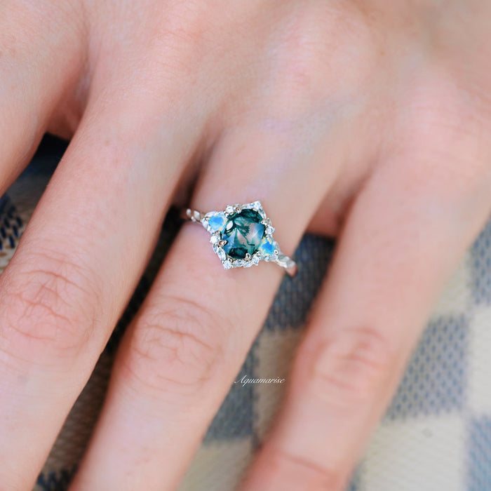 Moss Agate & Opalescent Sapphire Engagement Ring in 14K White Gold by Aquamarise Gold featuring a unique green moss agate center with opalescent sapphire accents on a delicate band.