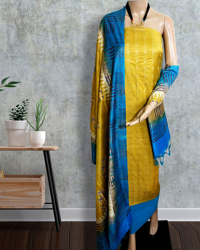 Mustard yellow and blue Katan silk suit set hand block printed in colour-blocked panels of linear grids, checkerboards and semi-circle motifs, with a fringed dupatta.