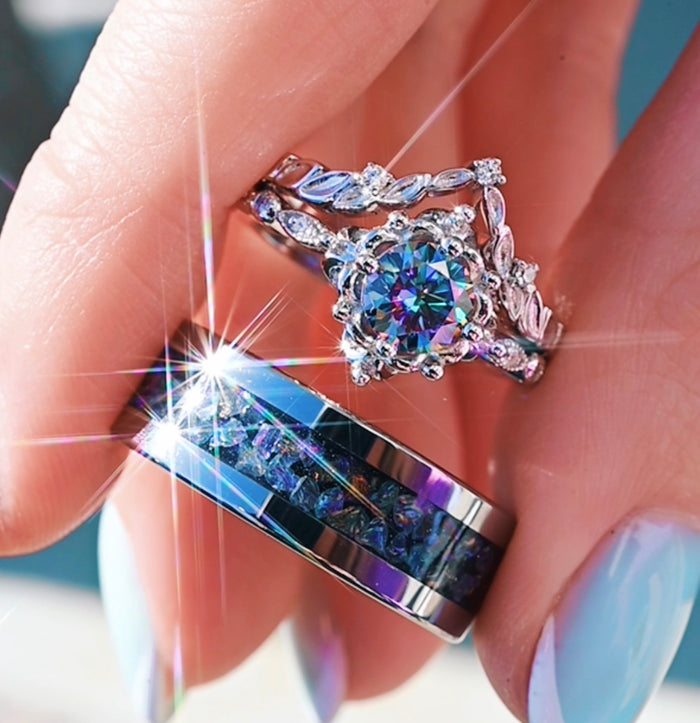 Close-up of a hand wearing two decorative rings with gemstones.