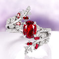 Red Garnet Leaf Ring Guard in 14K White Gold by Aquamarise Gold featuring a vibrant oval red garnet centerpiece with leaf and vine motifs accented by smaller red garnets and brilliant diamonds, part of January Birthstone Jewelry and Nature Inspired Jewelry Collection.
