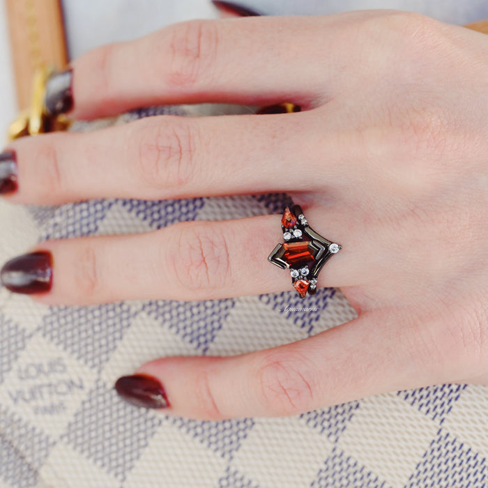 Natural Garnet & Red Fire Opal Couples Ring Set by Aquamarise featuring a coffin kite-shaped garnet and fire opal with small sparkling accents on a black-finished band.