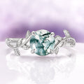 Natural Green Moss Agate Leaf Ring in Sterling Silver by Aquamarise featuring a vintage-inspired design with a round green moss agate stone and delicate leaf motifs on the band.