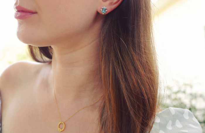 Natural London Blue Topaz Earrings in Sterling Silver worn by a woman, featuring emerald-cut blue topaz stones set in vintage-inspired sterling silver by Aquamarise.