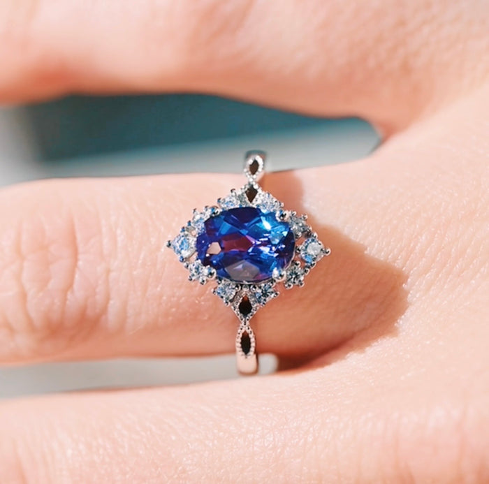 Nesta Alexandrite & Paula Shell Couples Ring Set featuring a striking oval alexandrite center stone with color-shifting brilliance, accented by delicate white diamonds and intricate milgrain detailing on a sterling silver band by Aquamarise, part of Matching Couples' Rings and June Birthstone Jewelry collections.