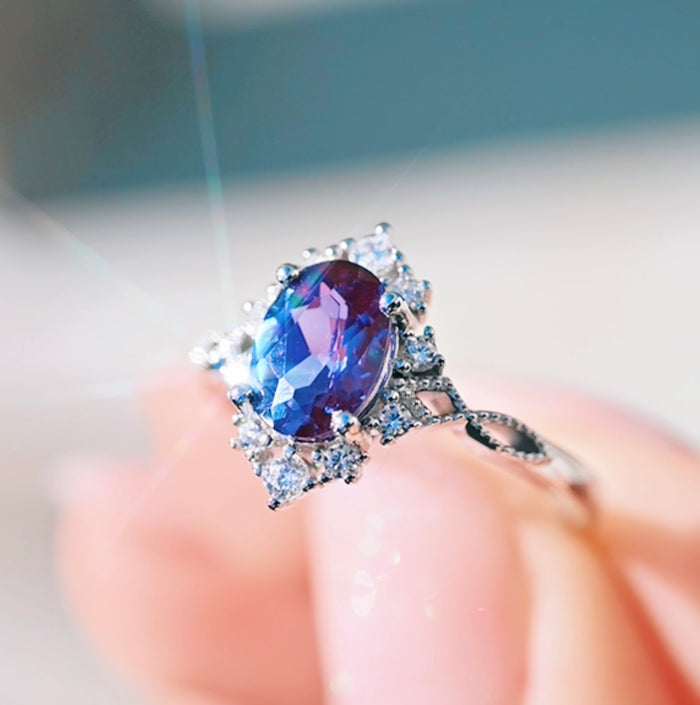 Nesta Alexandrite & Paula Shell Couples Ring Set from Aquamarise featuring an oval alexandrite gemstone with a natural color shift, surrounded by sparkling diamond accents on an intricately detailed sterling silver band, part of Matching Couples' Rings and June Birthstone Jewelry collections.