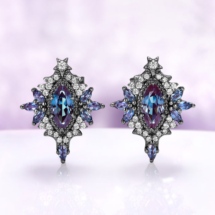 Nightbriar lab-grown alexandrite stud earrings in black ruthenium, marquise center stones in milgrain frames with alexandrite rays and a star crest