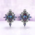 Nightbriar lab-grown alexandrite stud earrings in black ruthenium, marquise center stones in milgrain frames with alexandrite rays and a star crest