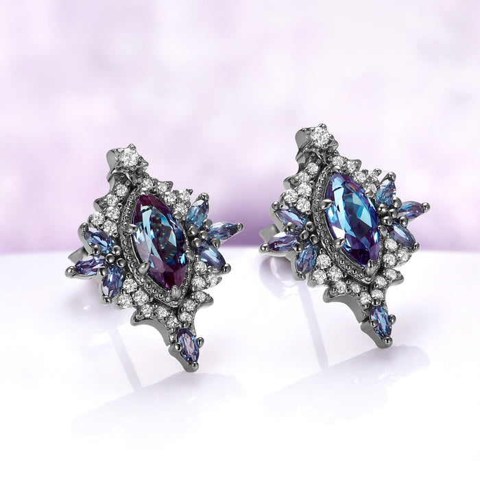 Angled view of the Nightbriar alexandrite stud earrings showing the teal-to-violet color shift, cubic zirconia halo and marquise point below the frame