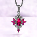 Nightbriar lab-grown ruby pendant necklace in black ruthenium, marquise center stone in a milgrain starburst frame on a box chain