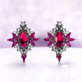 Nightbriar lab-grown ruby stud earrings in black ruthenium, marquise center stones in milgrain frames with ruby rays and a star crest
